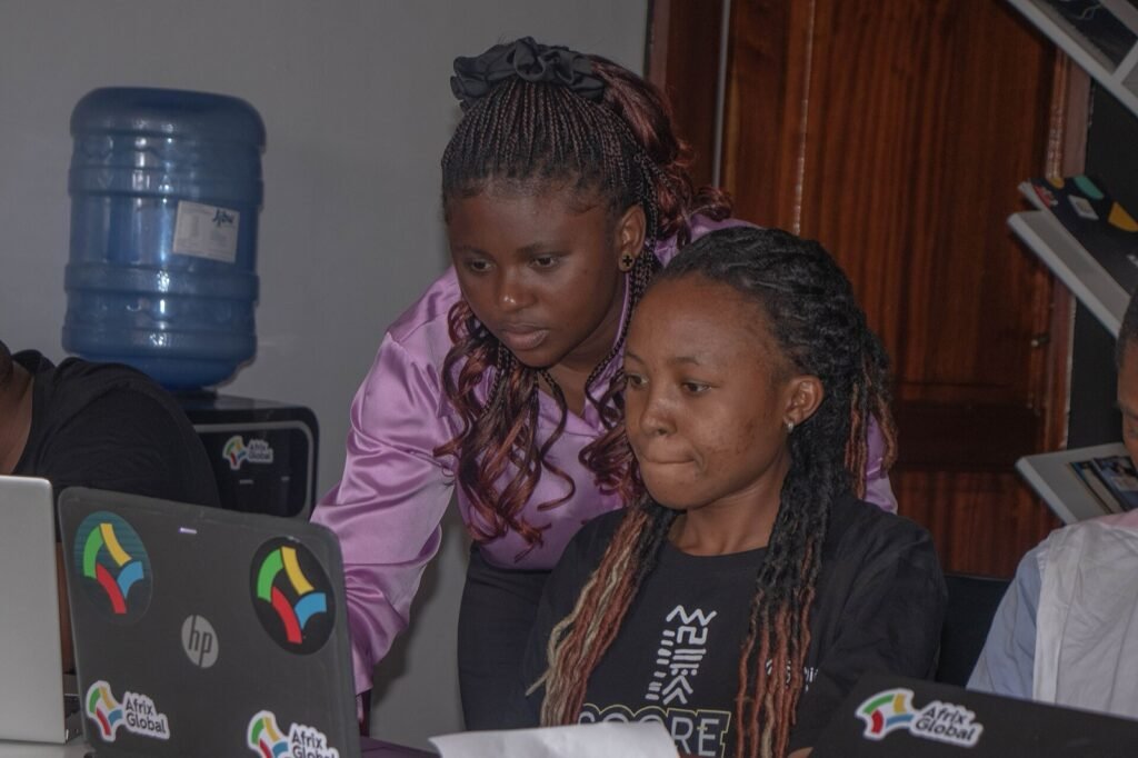 Deux jeunes femmes congolaises travaillent sur ordinateur portable lors d un atelier numérique en RDC